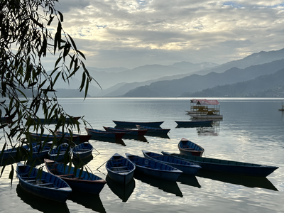 Boats floating on calm Phewa Lake in Pokhara