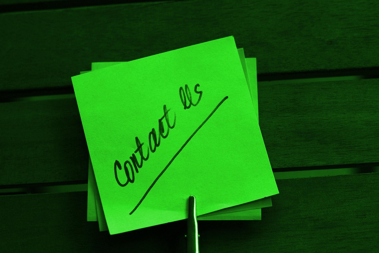Contact Us note written on green paper